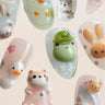 Joyee Nails Tiny Zoo collection — hand-sculpted 3D animal press-on nails featuring a frog, call duck, kitten, sea otter, bunny, and bear in pastel kawaii style, each individually built from gel by professional nail artists.