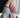 Lavender chrome almond press-on nails with iridescent shimmer finish — the trending purple nail design for 2026, paired with gold jewelry and cozy knit for a soft luxury look.