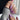 Lavender chrome almond press-on nails with iridescent shimmer finish — the trending purple nail design for 2026, paired with gold jewelry and cozy knit for a soft luxury look.