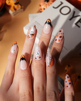 Monster Mash handmade Halloween press on nails with orange pumpkin, vampire, skeleton, stitches and bats on a sheer nude base - image 1