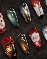 Séance gothic press on nails with a mask, dripping candles, lantern, skull and dagger on jewel tone cat eye with gold studs - image 1