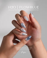 Great Barrier Blue short almond nails with silver-blue shell carvings, pearls, and chrome highlights