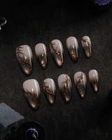 Black Briar press on nails with a nude to black cat eye ombre and raised gold thorn branches - image 2