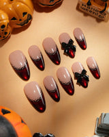 Vampire Lace press on nails with blood red French tips, hand-painted black lace trim and a 3D black bow on a nude base - image 2