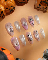 Pinkoween pink Halloween press on nails with pink pumpkins, a glitter ghost, silver bats and moons and holographic silver glitter nails - image 2