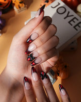 Vampire Lace press on nails with blood red French tips, hand-painted black lace trim and a 3D black bow on a nude base - image 3