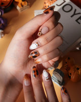 Leopard Boo press on nails with ghosts wearing leopard bows, amber tortoiseshell with gold chrome and leopard print French tips - image 4