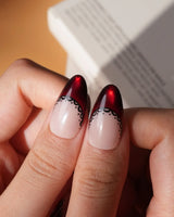 Vampire Lace press on nails with blood red French tips, hand-painted black lace trim and a 3D black bow on a nude base - image 4