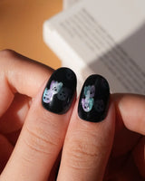 Party Spirits press on nails with holographic teal, lilac and pink glitter ghosts on a glossy black base - image 5