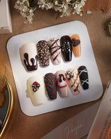 Chocolate Box press-on nails with chocolate bonbon accents and sweet bakery-inspired nail art