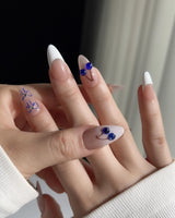 Klein Blue Cherry almond nails with modern cobalt fruit details on French tips