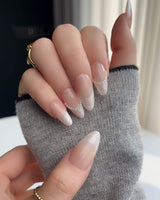 Dew Sparkle nude French tip nails with pearly finish, silk texture, and pearl accents