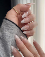 Close-up of Dew Sparkle nude French nails with pearl details and glossy silk texture