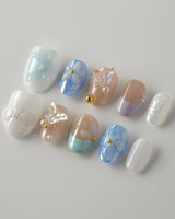 Aqua Petal custom press-ons with soft aqua petals, butterfly accents, and gel shine