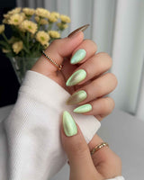 Aurora Mist handmade press-on nails featuring Champagne Nude, Green Aurora Cat Eye.