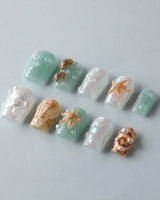 Mauritius Escape vacation nails with glossy mint shimmer, shell texture, and pearl drops