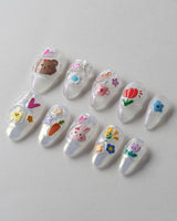 Squishy Pop short almond press-ons with cheerful decal nail art