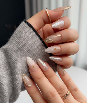 Venus nail art close-up showing Pearly Nude, 3D Shells & Gold. details