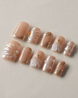 Venus sculpted shell nails with pearly nude gel and gold ornament details