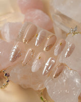 Venus pearly nude gel nails with 3D seashell accents and luxe gold details
