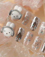 Miffy's Vacay handmade nails with glossy chrome shine and playful headphone rabbit detail