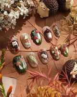 Close-up of Autumn Tales press-on nails with 3D hedgehog, mushrooms and forest-inspired details