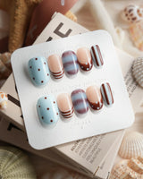 Cocoa Dot brown polka dot press-on nails with baby blue and marble accents
