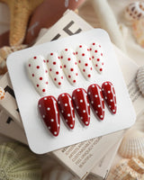 Creamy Cherry press-on nails with red and white polka dots with creamy cherry styling