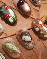 Autumn Tales press-on nails with hand-sculpted hedgehog, mushrooms and forest floor details