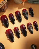 The Curse handmade press-on nails featuring red to black gradient glossy chrome studs gothic cross charm