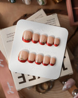 Bow French press-on nails — nude base red chrome french gold outline bow accent handmade nail art by Joyee Nails