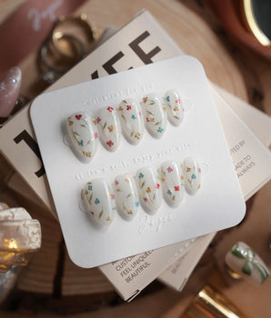Wildflower handmade press-on nails featuring Fresh Creamy White, Colorful Metallic Dainty Florals & Gold Wire Stems.