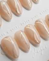 Oat Latte handmade press-on nails featuring Sheer Nude Skin, Minimalist Silver Glitter Swirls.