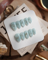 Soda Bubble handmade press-on nails featuring Fresh Icy Blue, Simple Gold Wire Bows & Rhinestones.