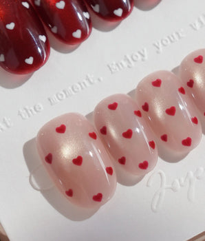Heart Collector handmade press-on nails featuring Vintage Red Pear, Contrasting Red & White Hearts, Cat-eye Shimmer