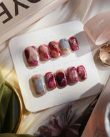 Baroque Palette press-on nails with baroque rose accents, glossy marble colors and gold details
