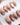 Caramel Petal press-on nails with rose chrome French tips, nude base and gold baroque details