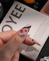 Alice in Wonderland handmade press-on nails in medium stiletto shape by Joyee Nails