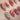 Baroque Palette press-on nails with pink and red marble swirls, gold outlines and rose accents