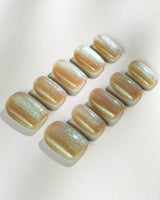 Aurora Mist press-on nails in medium square shape — Champagne Nude, Green Aurora Cat Eye.