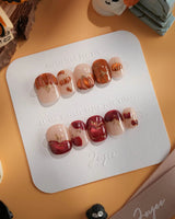Autumn Bounty press-on nails with orange pumpkin, red apple and gold outlined nude nails