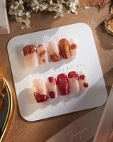 Autumn Bounty press-on nails with orange pumpkin charms, red apple accents and nude base