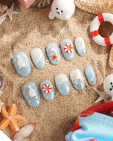 Baby Seals short oval nails with light blue ocean waves, 3D seal pups, and lifebuoys