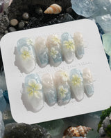 Bora Bora Blue island nails with ocean shimmer, sculpted plumeria, and wave texture