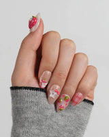 Berry Kitty close-up of sculpted berry hood character, fruit charms, and glossy pink-red details