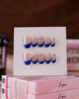 Blue French tip nails in a oval shape for a classic look.