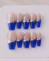Blue French tip nails with geometric patterns for a modern look.