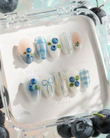 Blue Grid extra short almond nails with blue and white plaid and 3D blueberries
