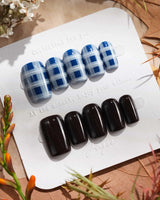 Fall-inspired plaid and solid black nails
