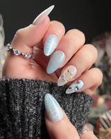 Winter wonderland nail art close-up showing Icy Blue Snowflakes, Rhinestone Wreath & Hearts. details
